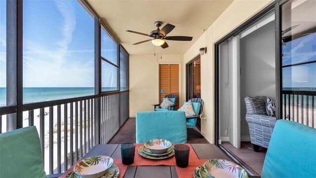 13720 Gulf Blvd Unit 305, Madeira Beach, FL 33708 - sunroom with a ceiling fan and a water view