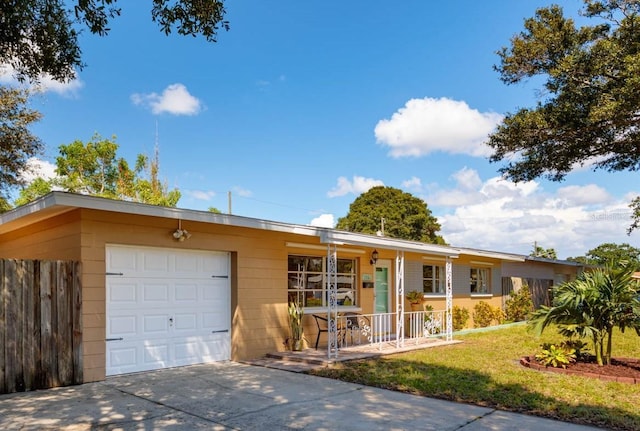 5561 24th Ter N, Saint Petersburg, FL 33710 - single story home with a porch, an attached garage, and driveway