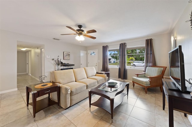 5561 24th Ter N, Saint Petersburg, FL 33710 - living room featuring a ceiling fan, light tile patterned floors, and baseboards