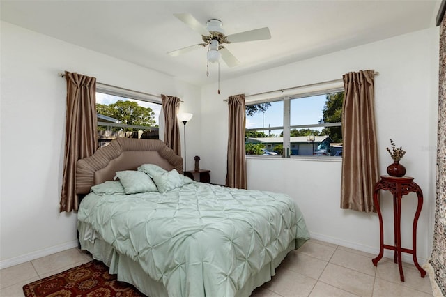 5561 24th Ter N, Saint Petersburg, FL 33710 - bedroom featuring multiple windows, light tile patterned flooring, and baseboards
