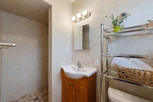 5561 24th Ter N, Saint Petersburg, FL 33710 - full bathroom featuring vanity, tiled shower, tile walls, and toilet