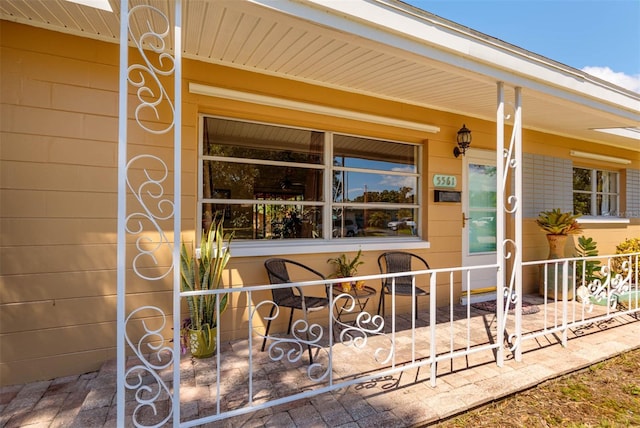 5561 24th Ter N, Saint Petersburg, FL 33710 - doorway to property featuring covered porch