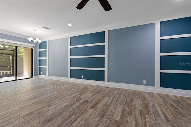 11442 Crowned Sparrow Ln, Tampa, FL 33626 - spare room with wood finished floors, visible vents, built in shelves, and ceiling fan with notable chandelier