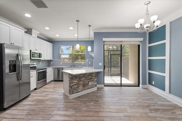 11442 Crowned Sparrow Ln, Tampa, FL 33626 - kitchen featuring tasteful backsplash, appliances with stainless steel finishes, ornamental molding, visible vents, and a peninsula