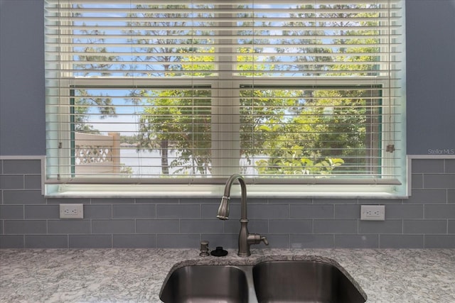 11442 Crowned Sparrow Ln, Tampa, FL 33626 - interior details with light stone counters, backsplash, and a sink