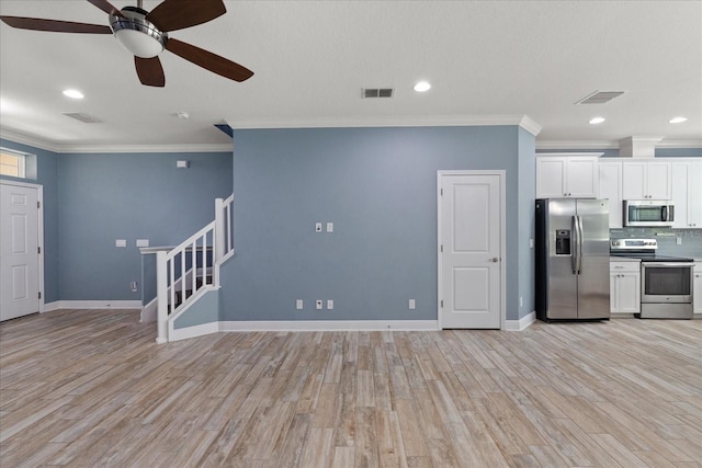 11442 Crowned Sparrow Ln, Tampa, FL 33626 - kitchen featuring visible vents, ceiling fan, appliances with stainless steel finishes, and white cabinetry