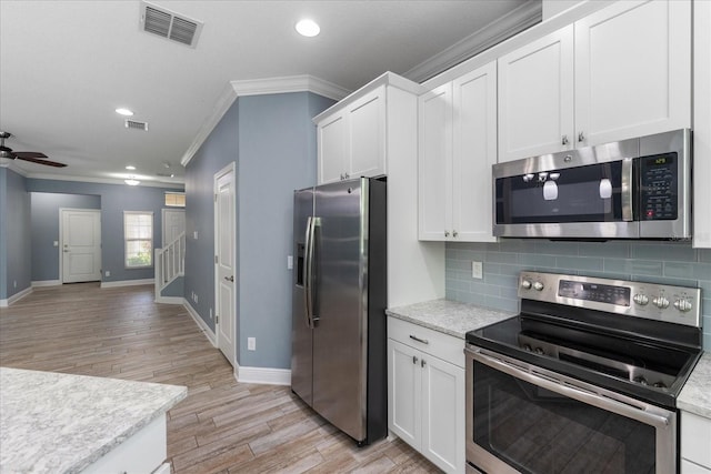 11442 Crowned Sparrow Ln, Tampa, FL 33626 - kitchen featuring light wood-style floors, appliances with stainless steel finishes, ornamental molding, backsplash, and visible vents