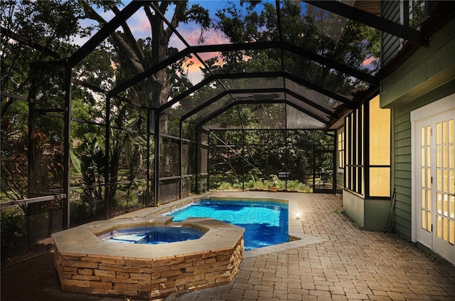 view of swimming pool with a patio area, a lanai, and a pool with connected hot tub