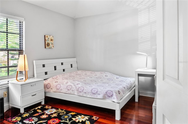 bedroom with dark wood-style floors
