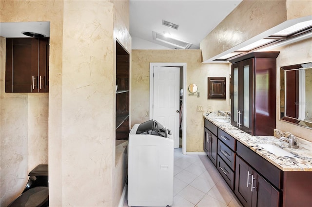 bathroom featuring visible vents, tile patterned floors, double vanity, and a sink