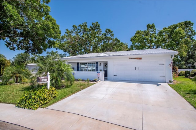 3408 90th Ter N, Pinellas Park, FL 33782 - ranch-style house featuring concrete driveway, stucco siding, metal roof, and a garage