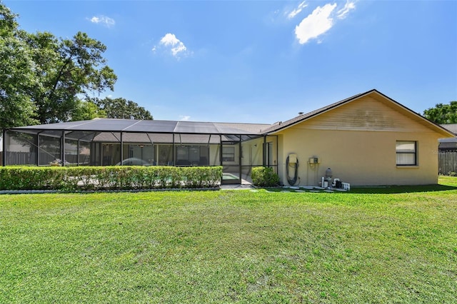 2914 Timber Knoll Dr, Valrico, FL 33596 - rear view of house with a lawn, stucco siding, and glass enclosure