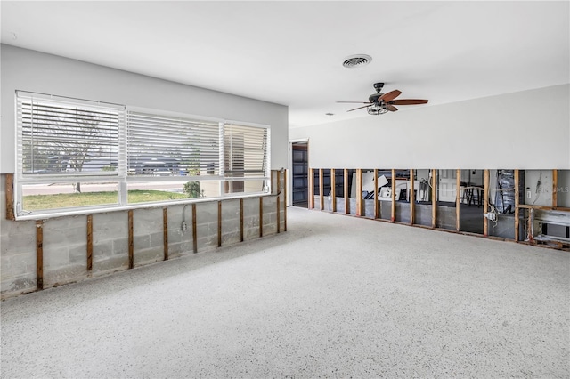 spare room featuring a ceiling fan, a healthy amount of sunlight, and visible vents