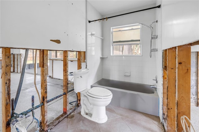 bathroom with bathing tub / shower combination, tile patterned flooring, and toilet