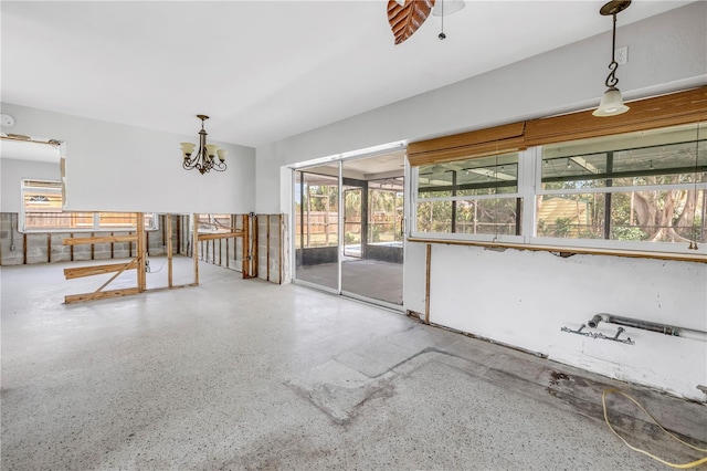 interior space featuring an inviting chandelier and speckled floor