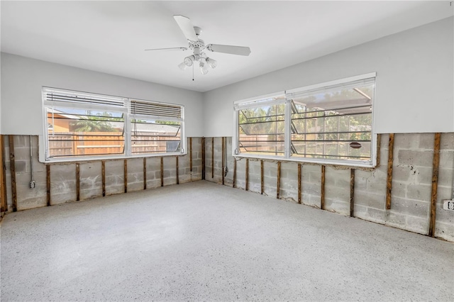 unfurnished room with a ceiling fan and speckled floor