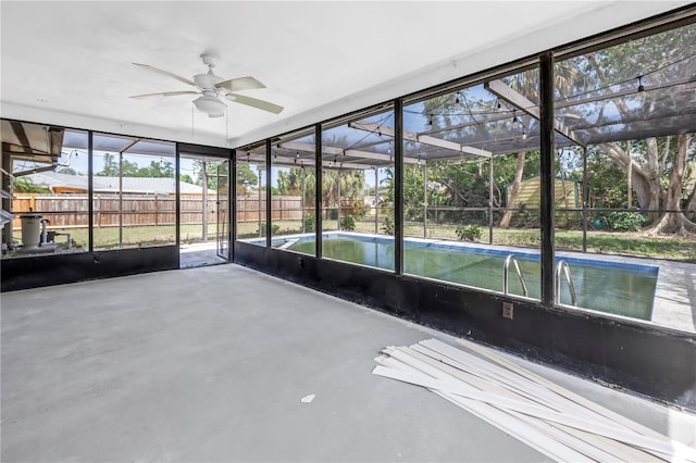 unfurnished sunroom featuring ceiling fan