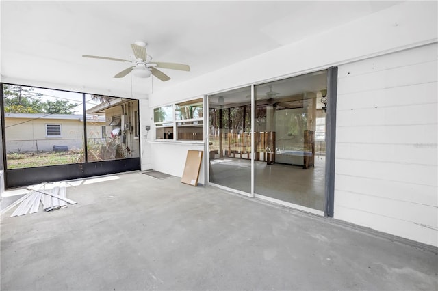 empty room with concrete flooring and a ceiling fan