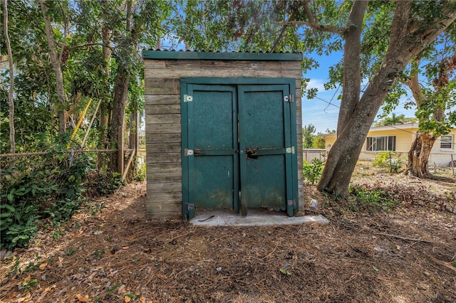 view of shed featuring fence