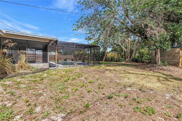 view of yard with glass enclosure