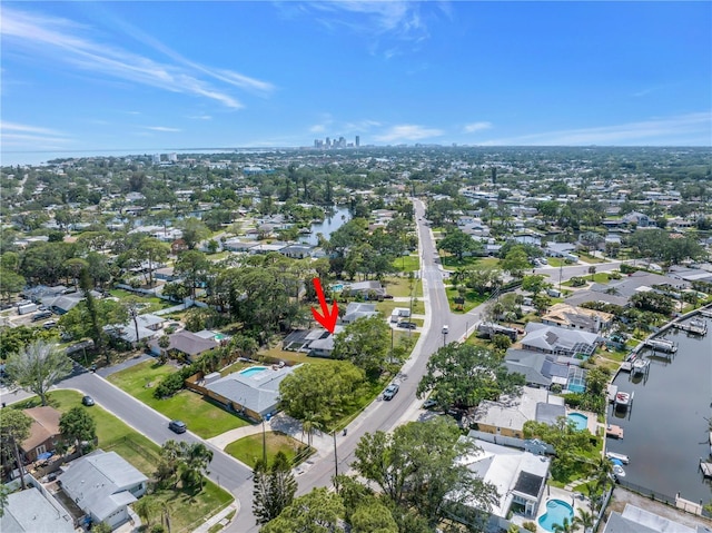 drone / aerial view featuring a residential view and a water view