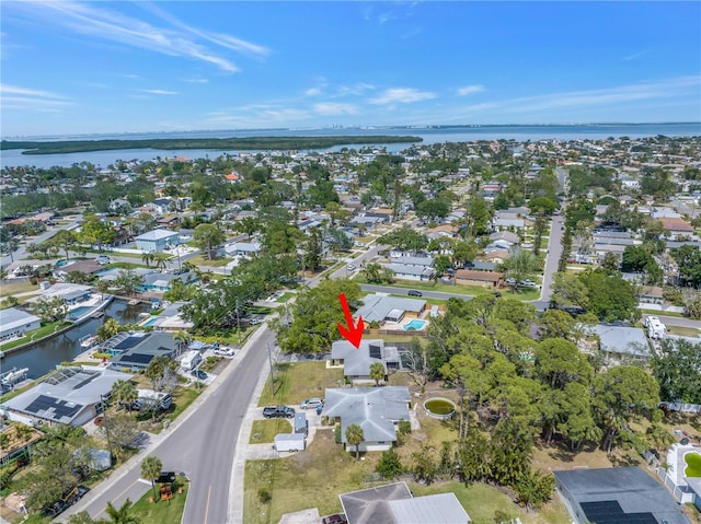 drone / aerial view featuring a water view and a residential view