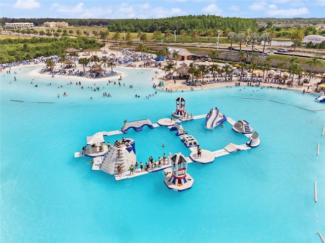 birds eye view of property featuring a beach view and a water view