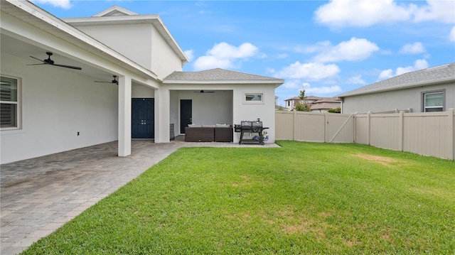 view of yard featuring a gate, outdoor lounge area, fence, ceiling fan, and a patio area