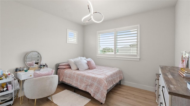 bedroom with baseboards and light wood-style floors
