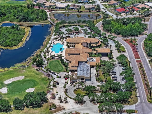 drone / aerial view with a water view and golf course view