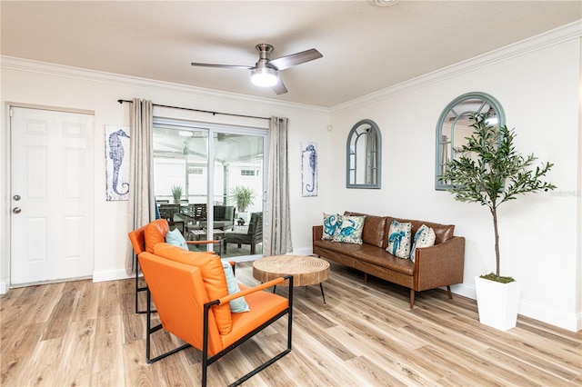 living room with ceiling fan, light wood-style flooring, baseboards, and ornamental molding