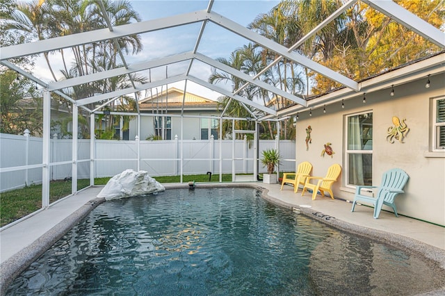 view of swimming pool featuring a fenced backyard, a lanai, a patio, and a fenced in pool