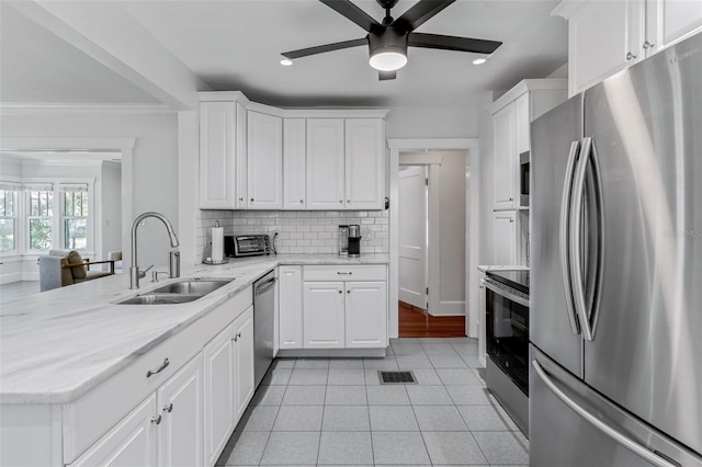 kitchen featuring a sink, visible vents, decorative backsplash, ceiling fan, and appliances with stainless steel finishes