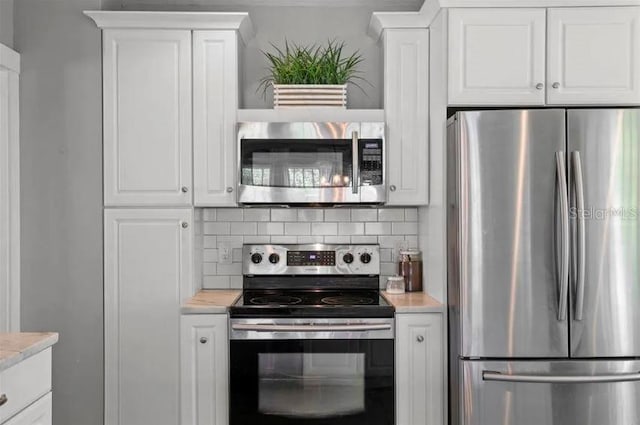kitchen with stainless steel appliances, light countertops, white cabinetry, and tasteful backsplash