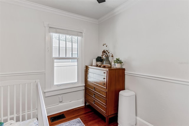 bedroom with dark wood-type flooring, a ceiling fan, and ornamental molding