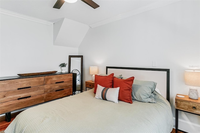 bedroom featuring ceiling fan, crown molding, and wood finished floors