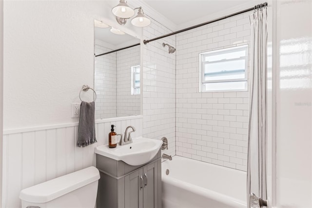 full bathroom featuring shower / bathing tub combination, wainscoting, vanity, and toilet