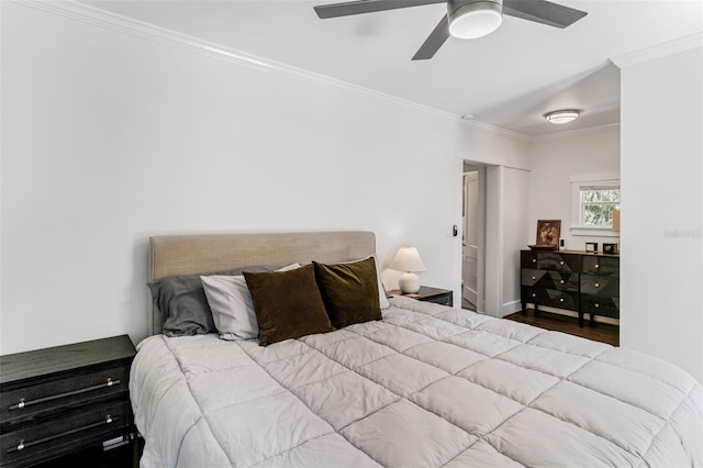 bedroom featuring ceiling fan, wood finished floors, and ornamental molding