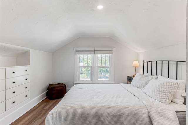 bedroom featuring vaulted ceiling, wood finished floors, and baseboards
