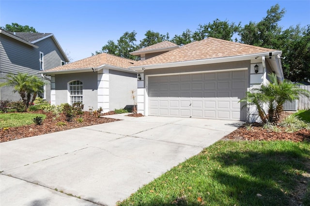 ranch-style home with stucco siding, concrete driveway, roof with shingles, and an attached garage