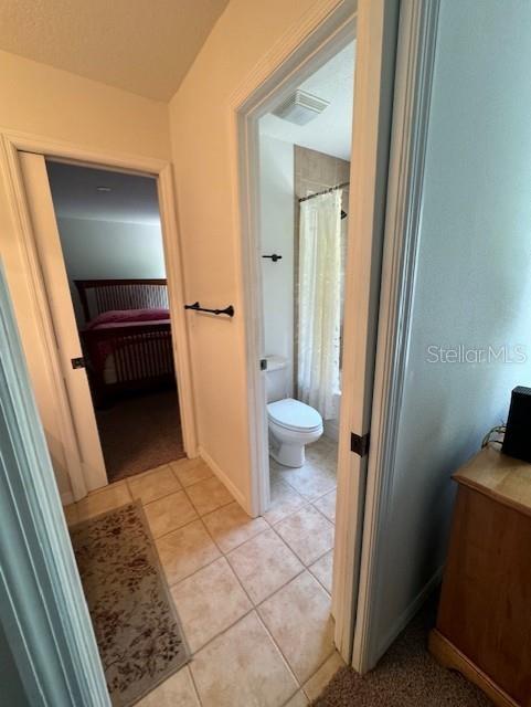 full bathroom with visible vents, ensuite bath, tile patterned flooring, and toilet