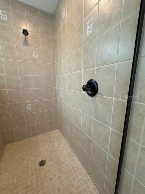 full bath with a tile shower