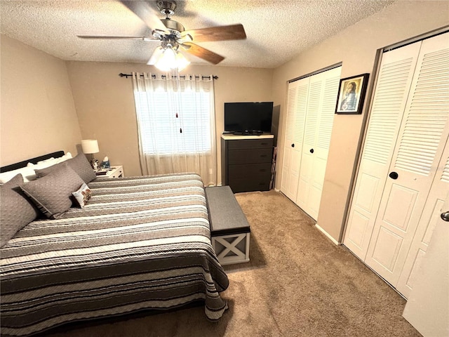 13924 Pathfinder Dr, Tampa, FL 33625 - bedroom featuring multiple closets, light colored carpet, a textured ceiling, and a ceiling fan