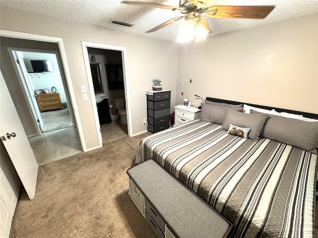 13924 Pathfinder Dr, Tampa, FL 33625 - bedroom featuring light carpet, a textured ceiling, ensuite bath, and ceiling fan