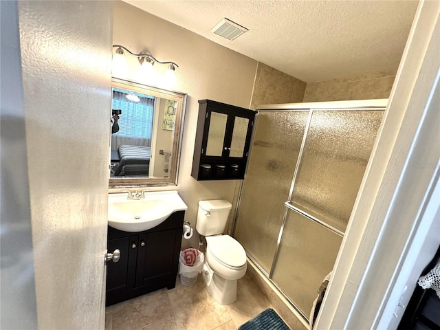 13924 Pathfinder Dr, Tampa, FL 33625 - bathroom with a textured ceiling, a shower stall, vanity, toilet, and tile patterned flooring