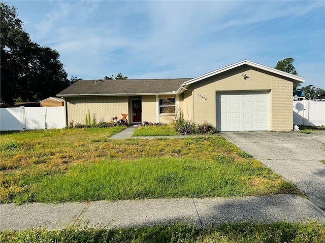 13924 Pathfinder Dr, Tampa, FL 33625 - ranch-style house featuring an attached garage, asphalt driveway, a gate, stucco siding, and brick siding