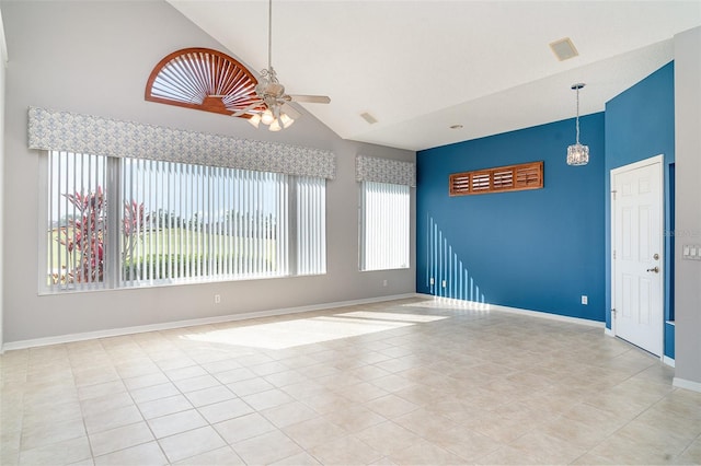 spare room featuring a healthy amount of sunlight, high vaulted ceiling, and a ceiling fan
