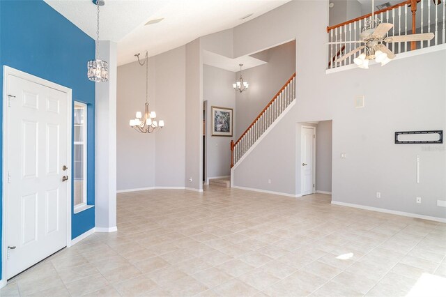 foyer entrance with stairs, light tile patterned flooring, baseboards, high vaulted ceiling, and a chandelier