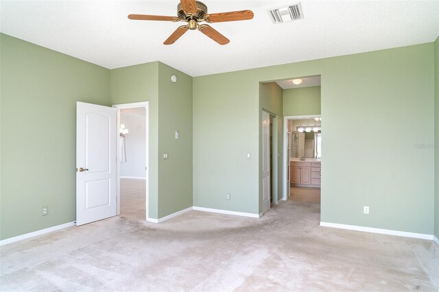 unfurnished bedroom with baseboards, visible vents, and light carpet