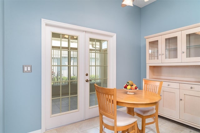 dining space with french doors and light tile patterned floors